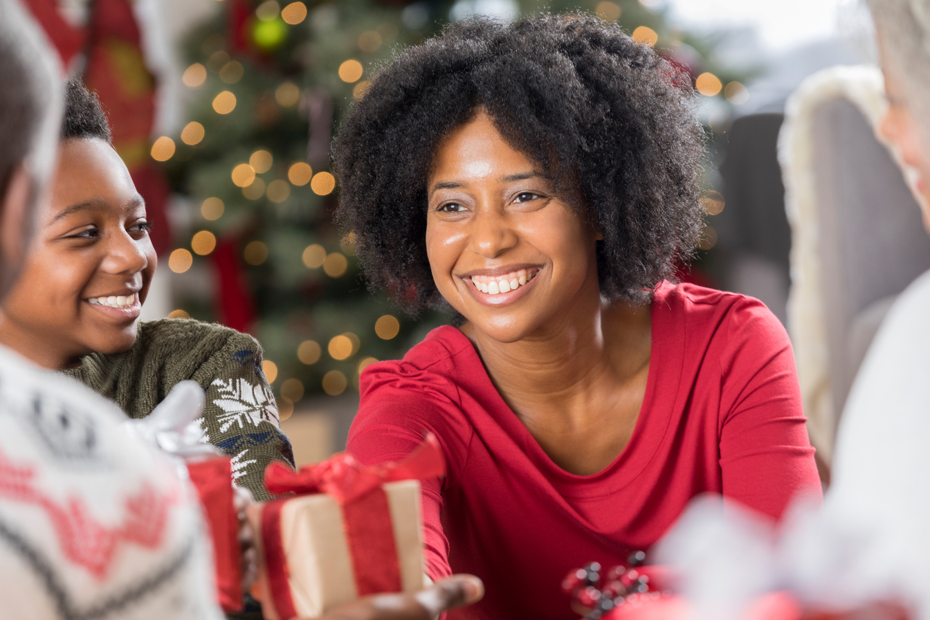 Smiling woman receives Christmas gift